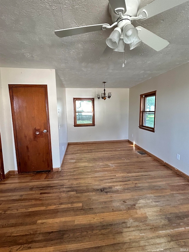 spare room with ceiling fan, wood-type flooring, and a textured ceiling