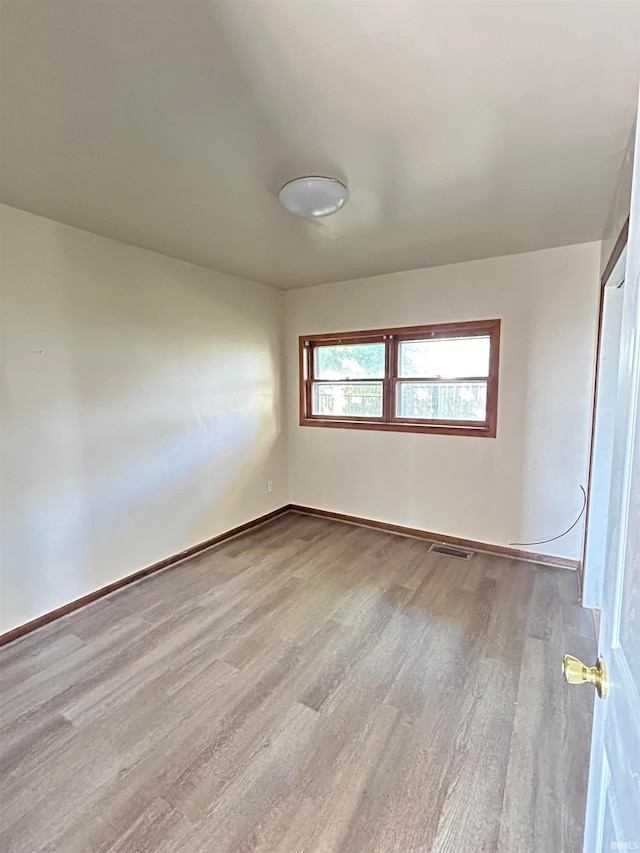 spare room with light hardwood / wood-style flooring