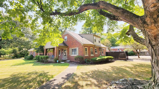 view of front of home with a front yard and covered porch