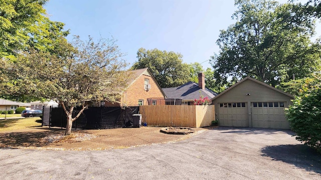 view of front of property with a garage and an outbuilding