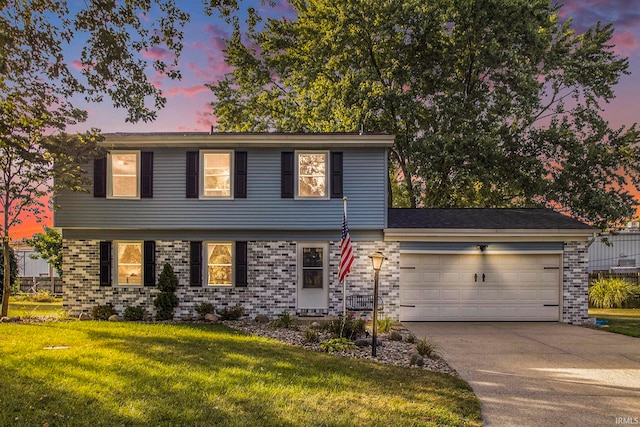 view of front of property featuring a lawn and a garage