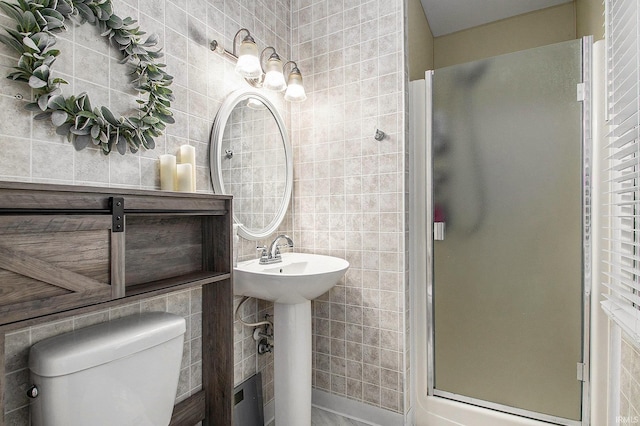 bathroom with toilet and an enclosed shower