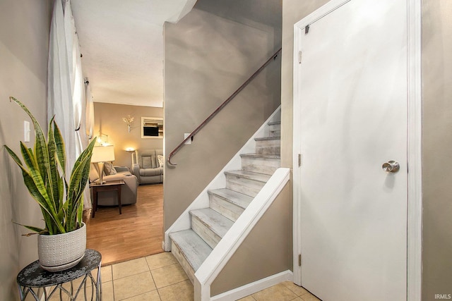 stairway with hardwood / wood-style floors