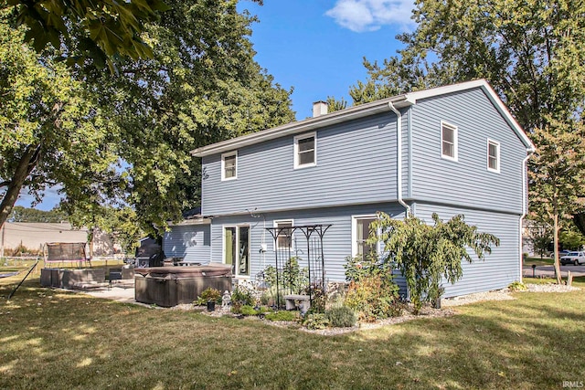 rear view of house featuring a lawn