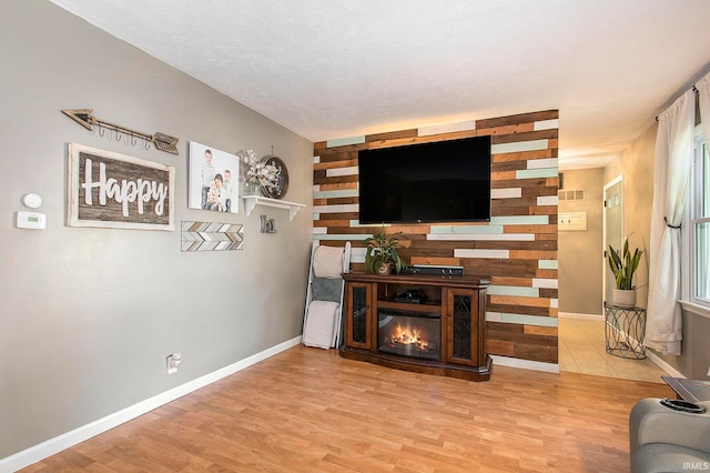 living room featuring a textured ceiling and light hardwood / wood-style flooring