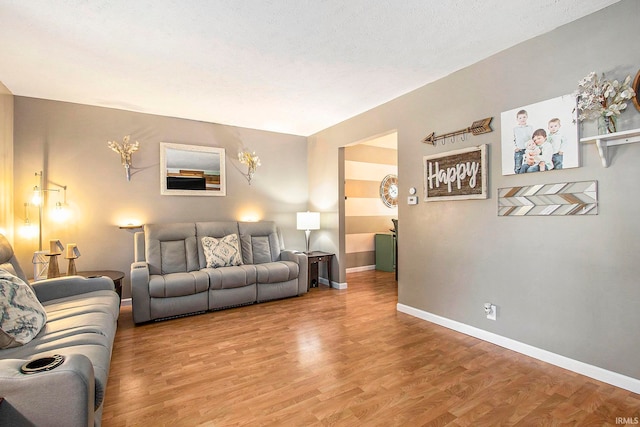 living room featuring a textured ceiling and hardwood / wood-style flooring