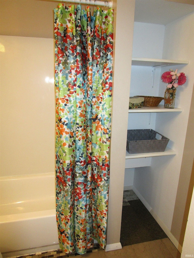 bathroom featuring tile patterned flooring and shower / bathtub combination with curtain