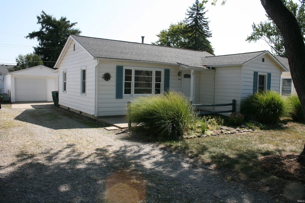 view of front facade featuring an outdoor structure and a garage