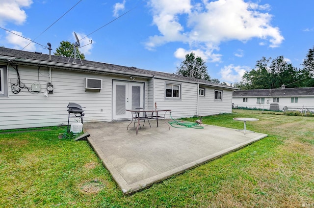 back of property with a yard, central AC, and a patio