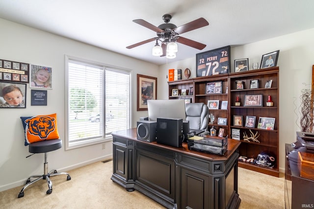 carpeted office space with ceiling fan and plenty of natural light