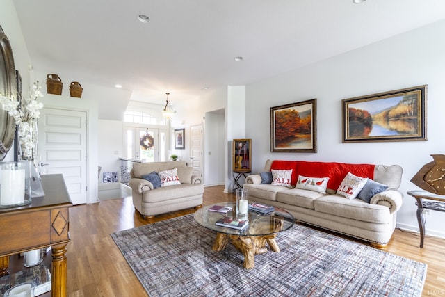 living area with wood finished floors and recessed lighting