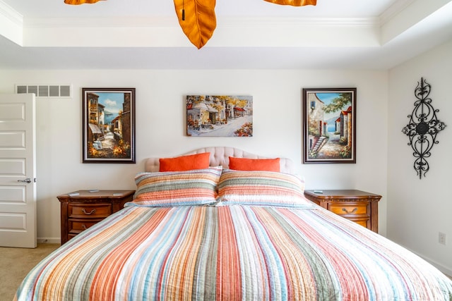 bedroom with a raised ceiling, light carpet, and ornamental molding