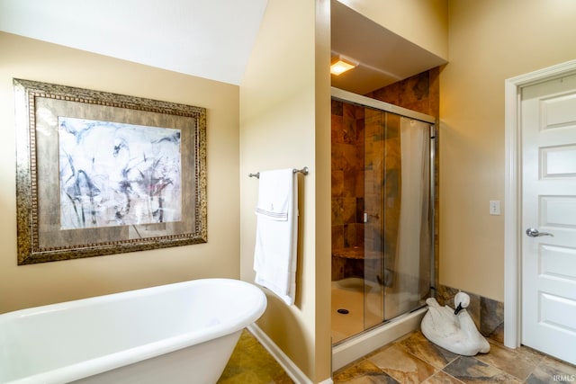 bathroom featuring lofted ceiling and separate shower and tub