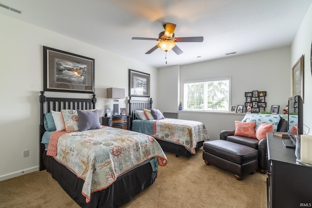 bedroom featuring visible vents, a ceiling fan, and light carpet