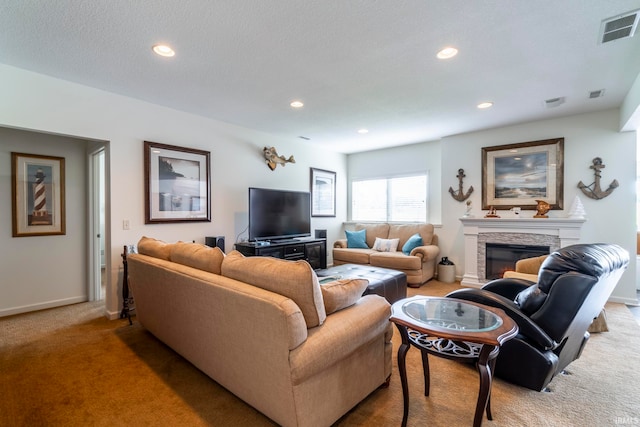 living room featuring a textured ceiling, carpet, and a fireplace