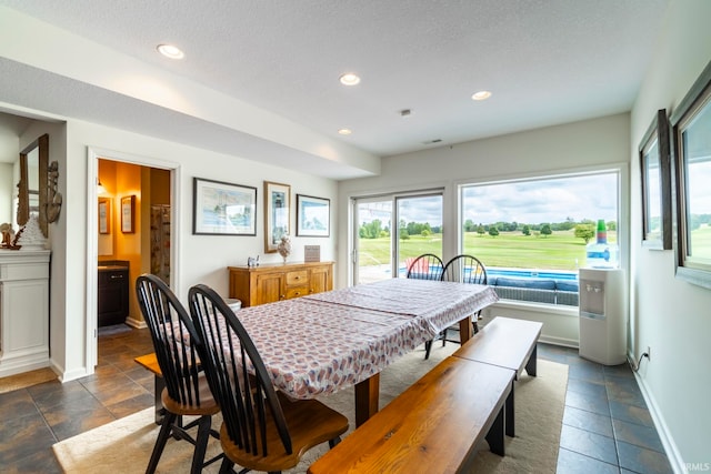 dining area featuring a textured ceiling