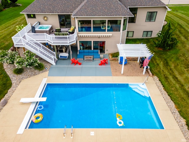 view of pool featuring a yard, a diving board, and a patio area