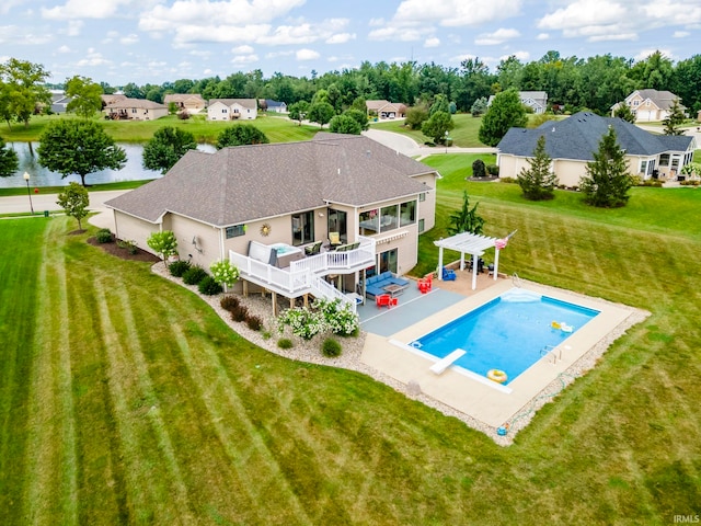 view of pool with a deck with water view, a yard, a grill, a diving board, and a patio