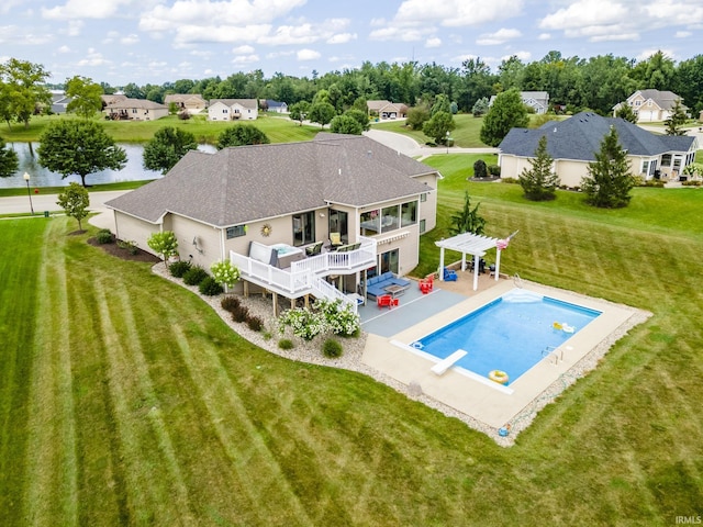 back of property featuring a pergola, an outdoor pool, a yard, a deck with water view, and roof with shingles