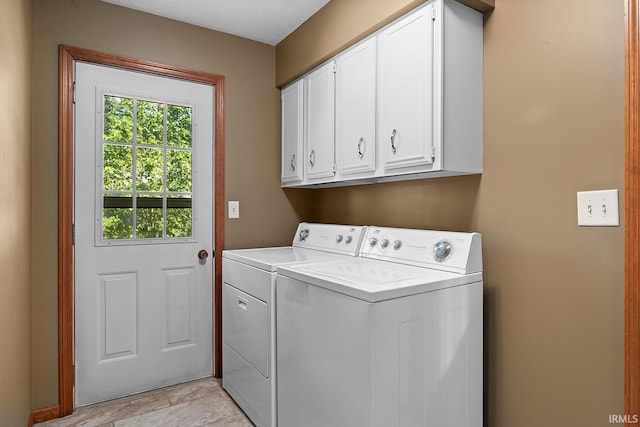 laundry room with independent washer and dryer and cabinets