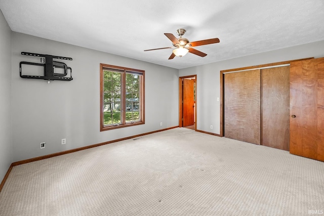 unfurnished bedroom with a textured ceiling, ceiling fan, and carpet floors