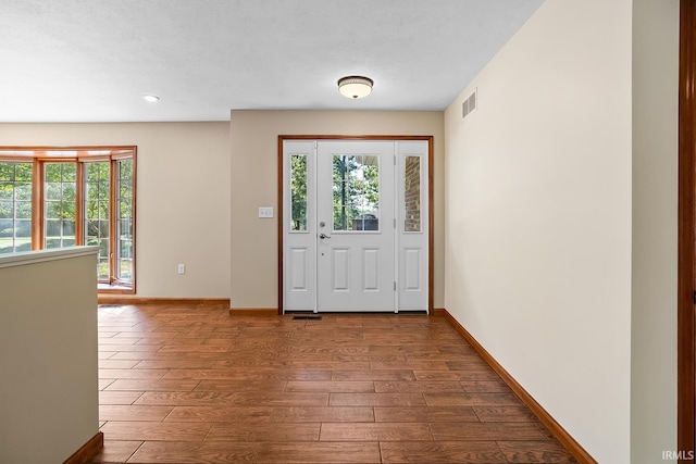 entrance foyer featuring hardwood / wood-style flooring and a textured ceiling