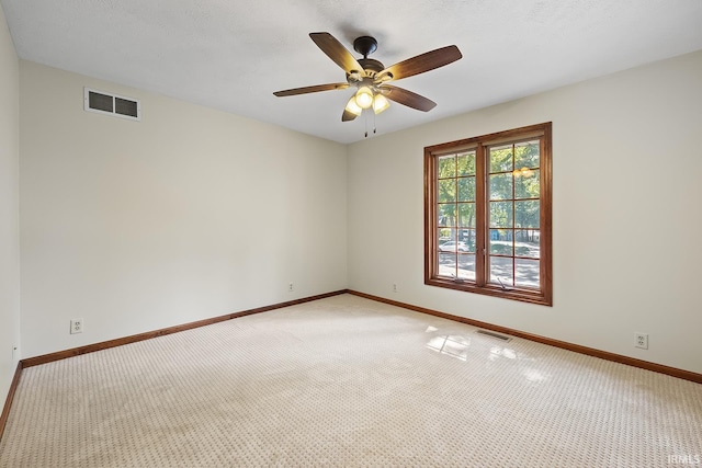 carpeted empty room featuring ceiling fan