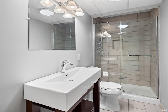 bathroom featuring vanity, toilet, and an enclosed shower