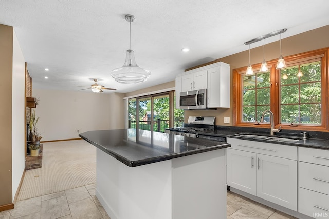 kitchen with a center island, a healthy amount of sunlight, stainless steel appliances, and sink