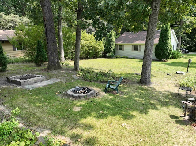 view of yard with an outdoor fire pit