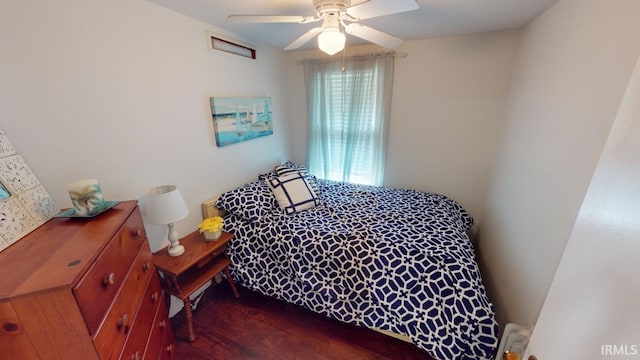 bedroom featuring dark wood-type flooring, ceiling fan, and radiator heating unit