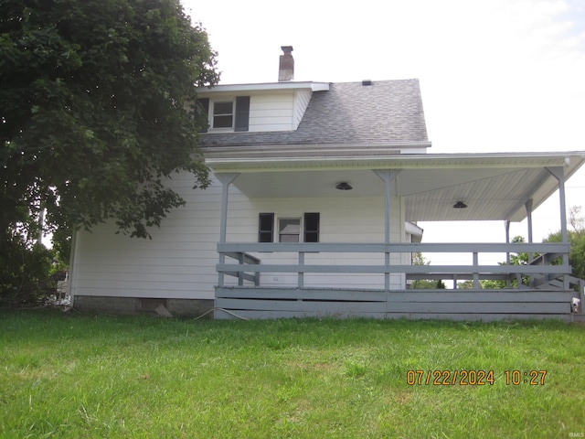 rear view of house featuring a yard