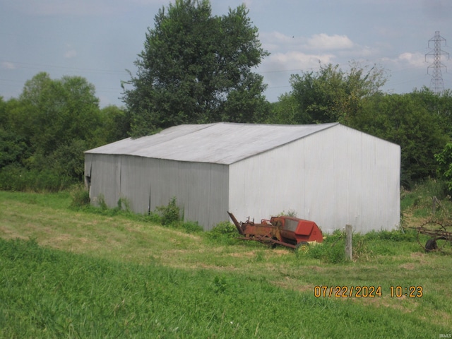 view of outbuilding with a yard