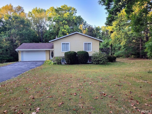 split level home featuring a front yard and a garage