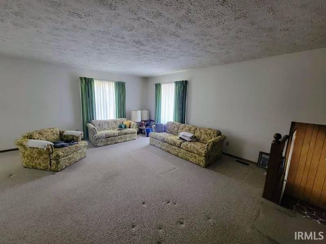 unfurnished living room featuring carpet and a textured ceiling