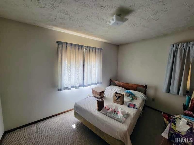 carpeted bedroom with a textured ceiling