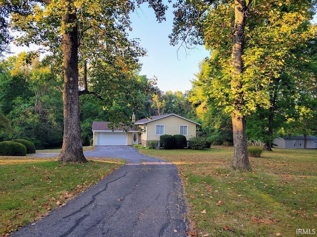 view of front facade with a front lawn and a garage