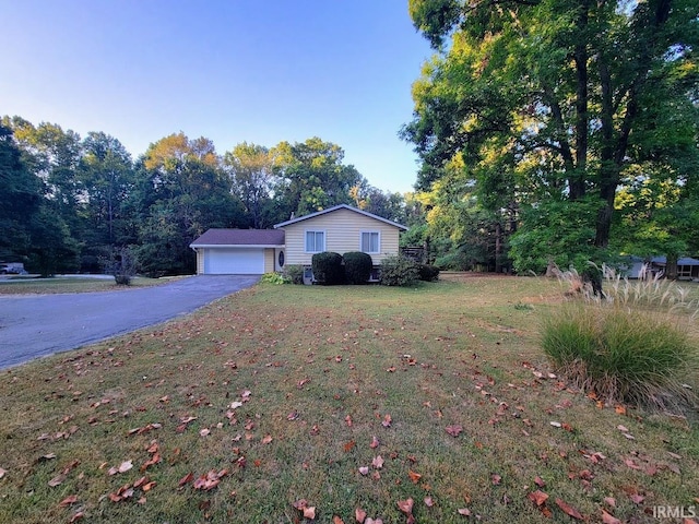 view of front of home with a garage and a front lawn