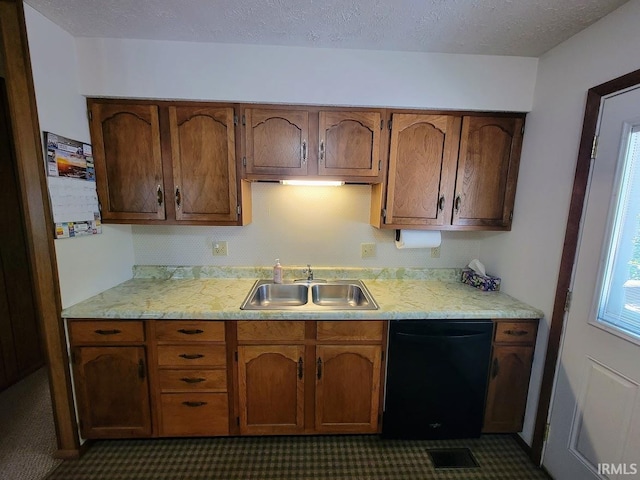 kitchen featuring sink, a textured ceiling, and black dishwasher