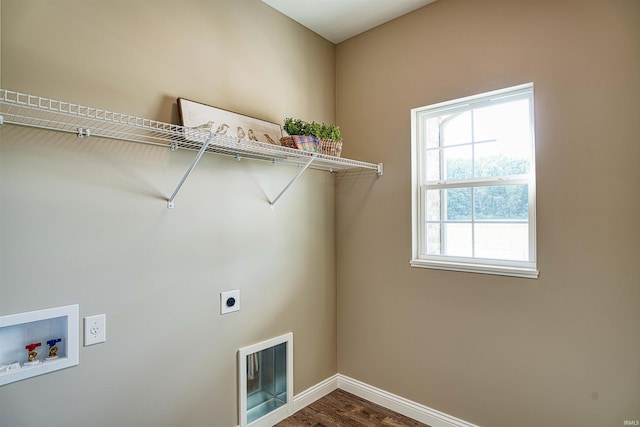 washroom featuring hookup for a washing machine, hardwood / wood-style floors, and hookup for an electric dryer