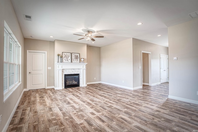 unfurnished living room with ceiling fan and wood-type flooring