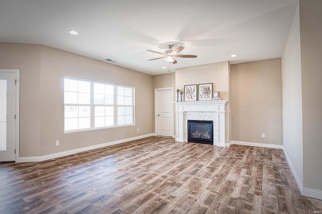 unfurnished living room featuring ceiling fan and wood-type flooring