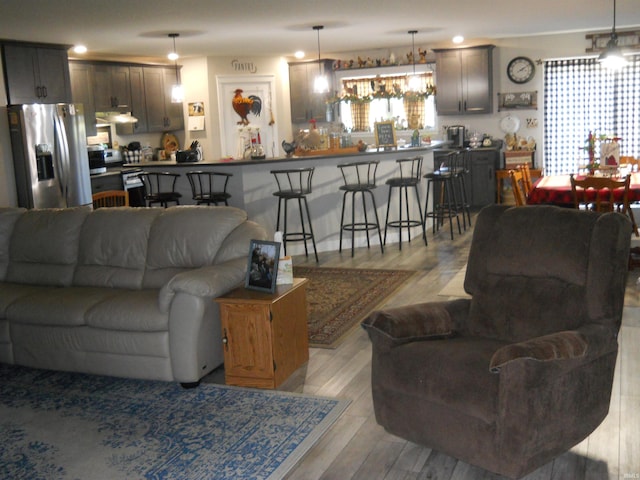 living room with light wood-type flooring and indoor bar