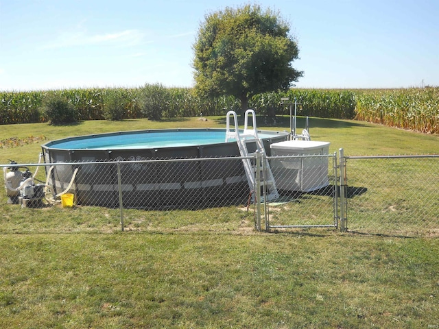 view of swimming pool with a yard