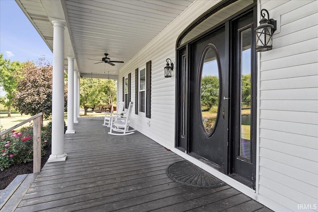 wooden deck featuring ceiling fan and covered porch