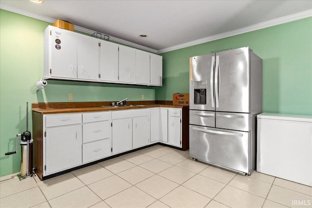 kitchen featuring stainless steel refrigerator with ice dispenser, ornamental molding, light tile patterned flooring, and white cabinets