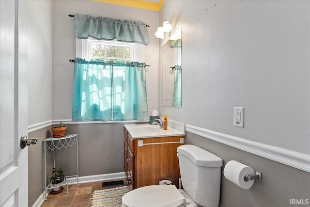 bathroom with toilet and vanity