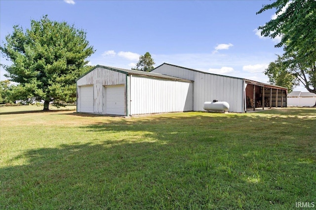 view of outbuilding with a lawn and a garage