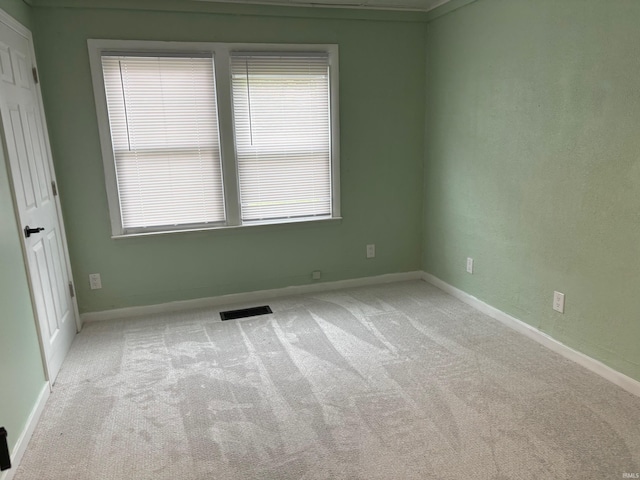 empty room featuring light carpet