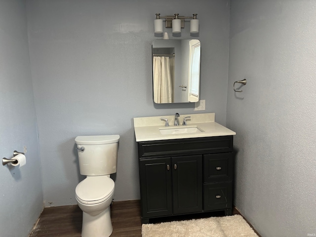 bathroom featuring hardwood / wood-style floors, toilet, and vanity